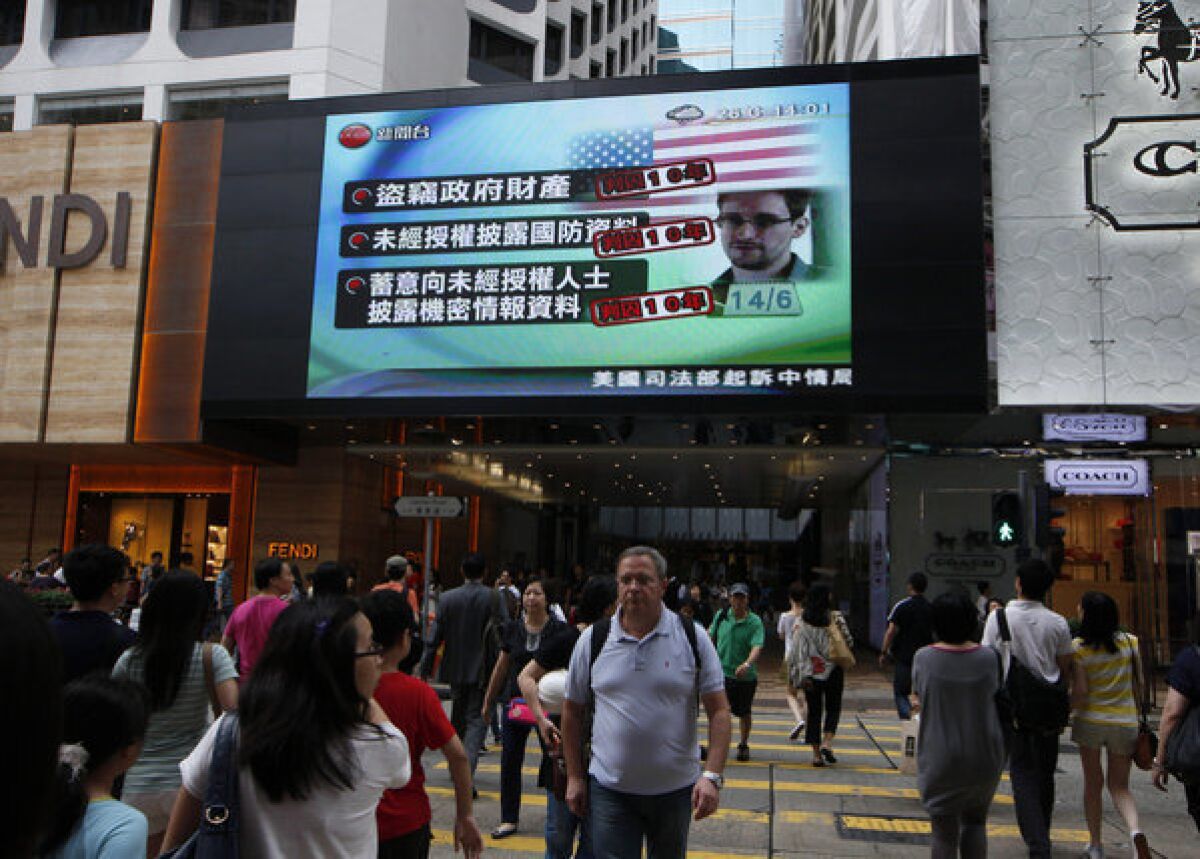 A TV screen at a Hong Kong mall shows a news report about Edward Snowden, who leaked top-secret documents about sweeping U.S. surveillance programs.