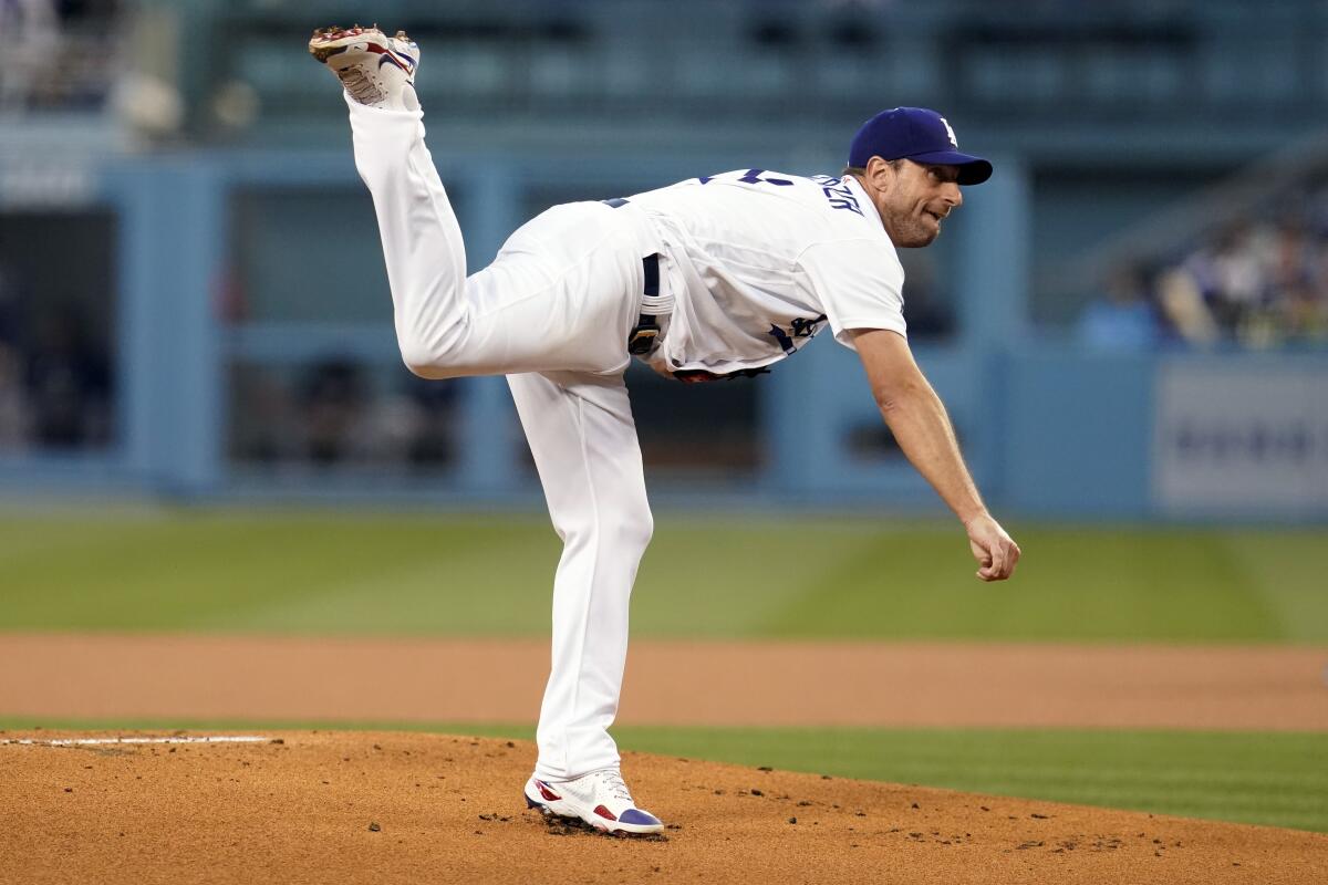 Dodgers pitcher Max Scherzer follows through on a pitch to an Atlanta Braves batter.