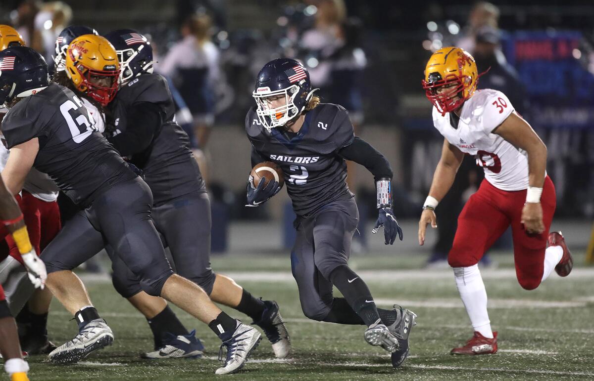 Running back Hayden Farley runs through a hole during Friday's game against Dominguez.