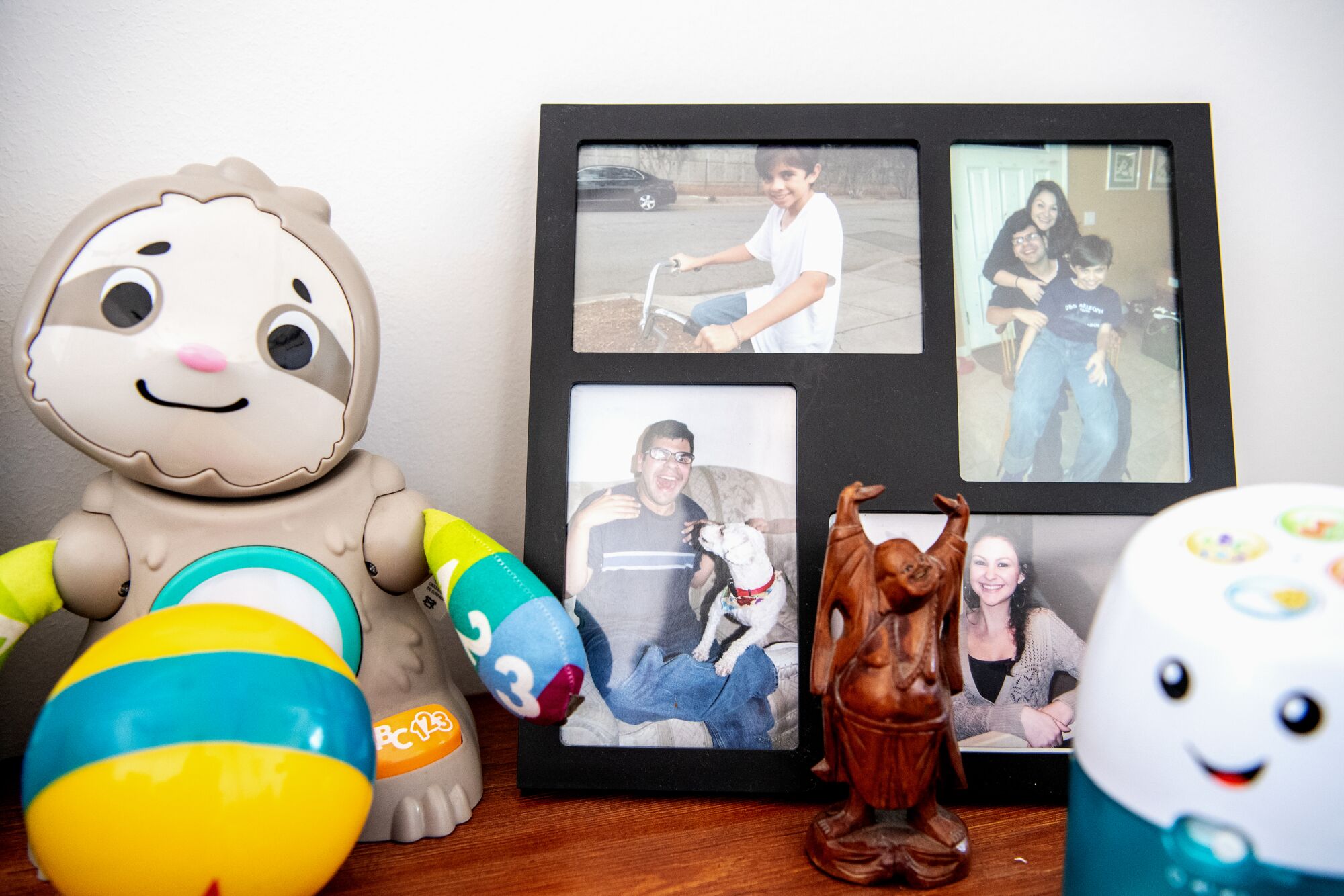 Toys surround a framed set of family pictures.
