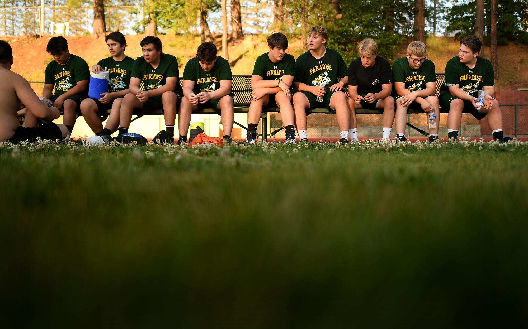 Paradise football players take a break during a team training camp session.