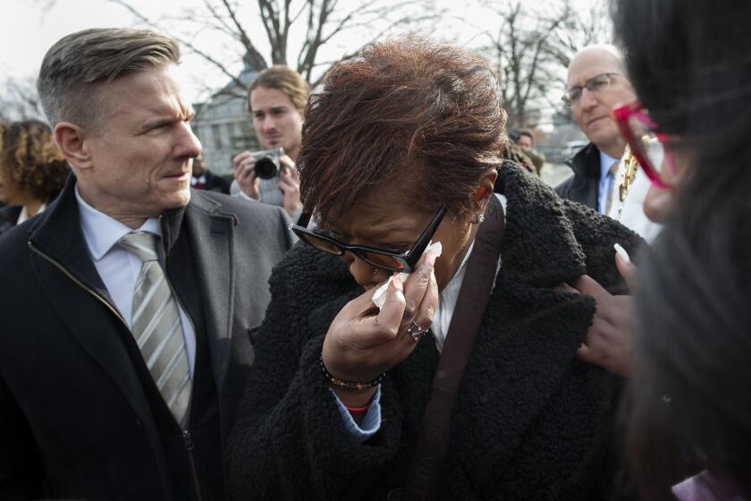 FILE - Pamela Walker, mother of Jayland Walker, who was shot and killed by police in Akron, Ohio, is comforted on Capitol Hill in Washington, on Feb. 7, 2023. (AP Photo/Cliff Owen, File)