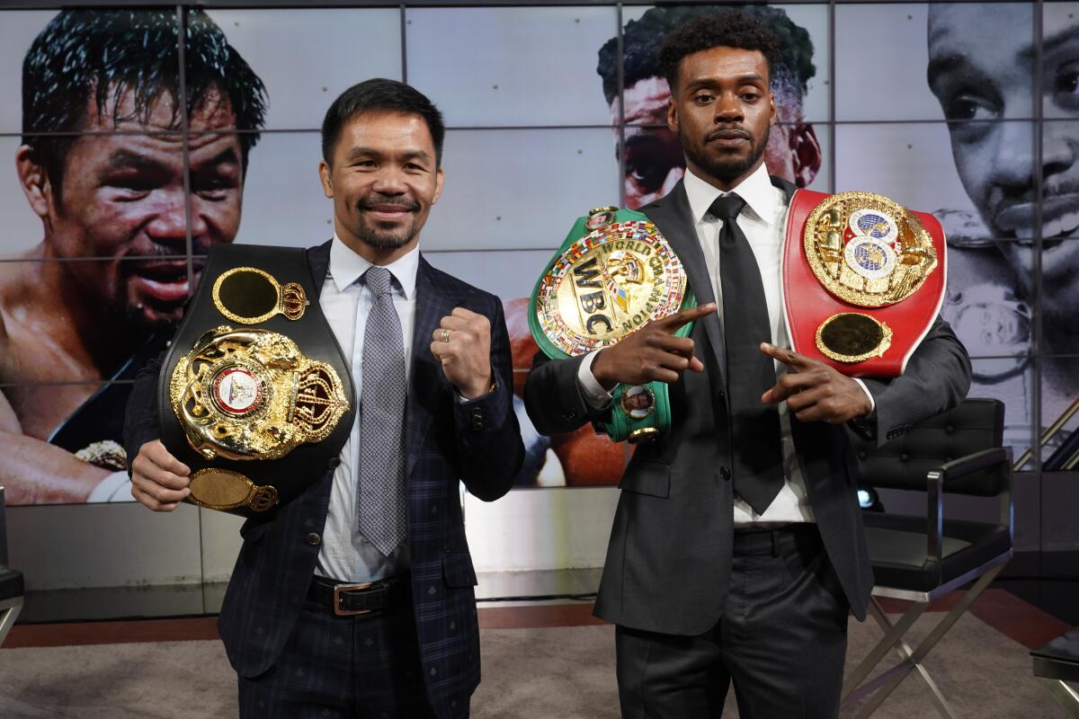 Manny Pacquiao, left, and Errol Spence Jr., pose for a photo at a news conference at the Fox Studios lot in Los Angeles ahead of their upcoming boxing match, taking place in Las Vegas on Aug. 21, in Los Angeles Sunday, July 11, 2021. (AP Photo/Damian Dovarganes)