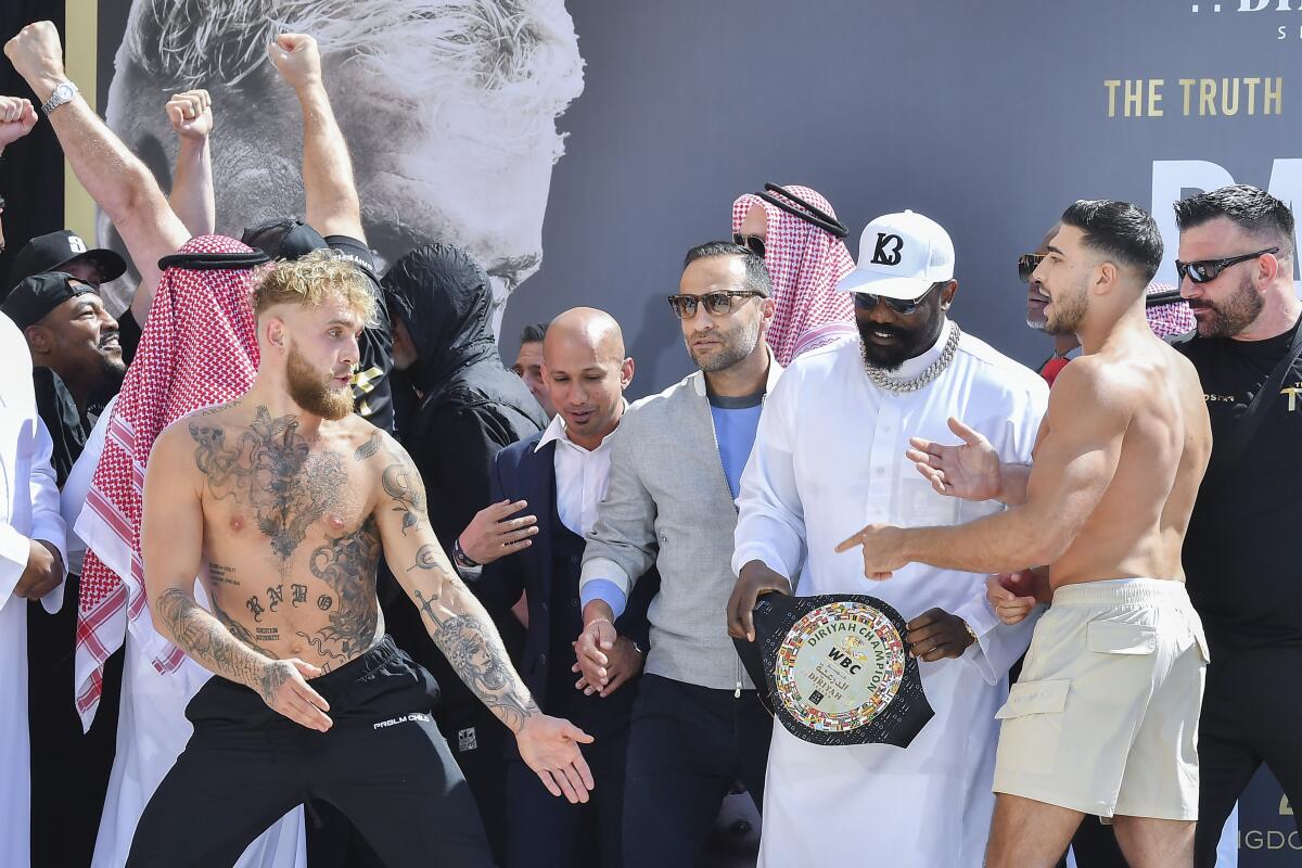 YouTube star Jake Paul and boxer Tommy Fury pose after a weigh-in a day before their match in Riyadh