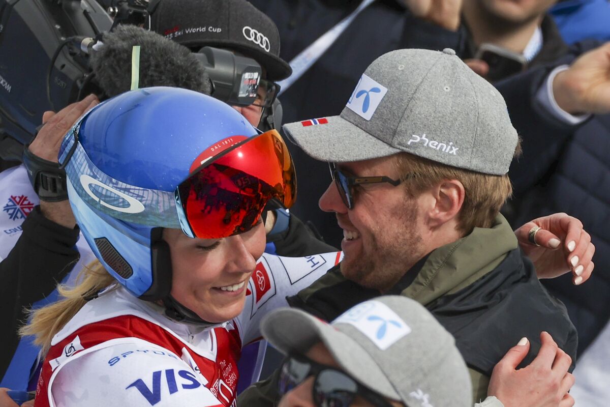 United States' Mikaela Shiffrin, left, hugs Norway's Aleksander Aamodt Kilde as they stand in the finish area of an alpine ski, women's World Cup Finals downhill, in Courchevel, France, Wednesday, March 16, 2022. (AP Photo/Alessandro Trovati)