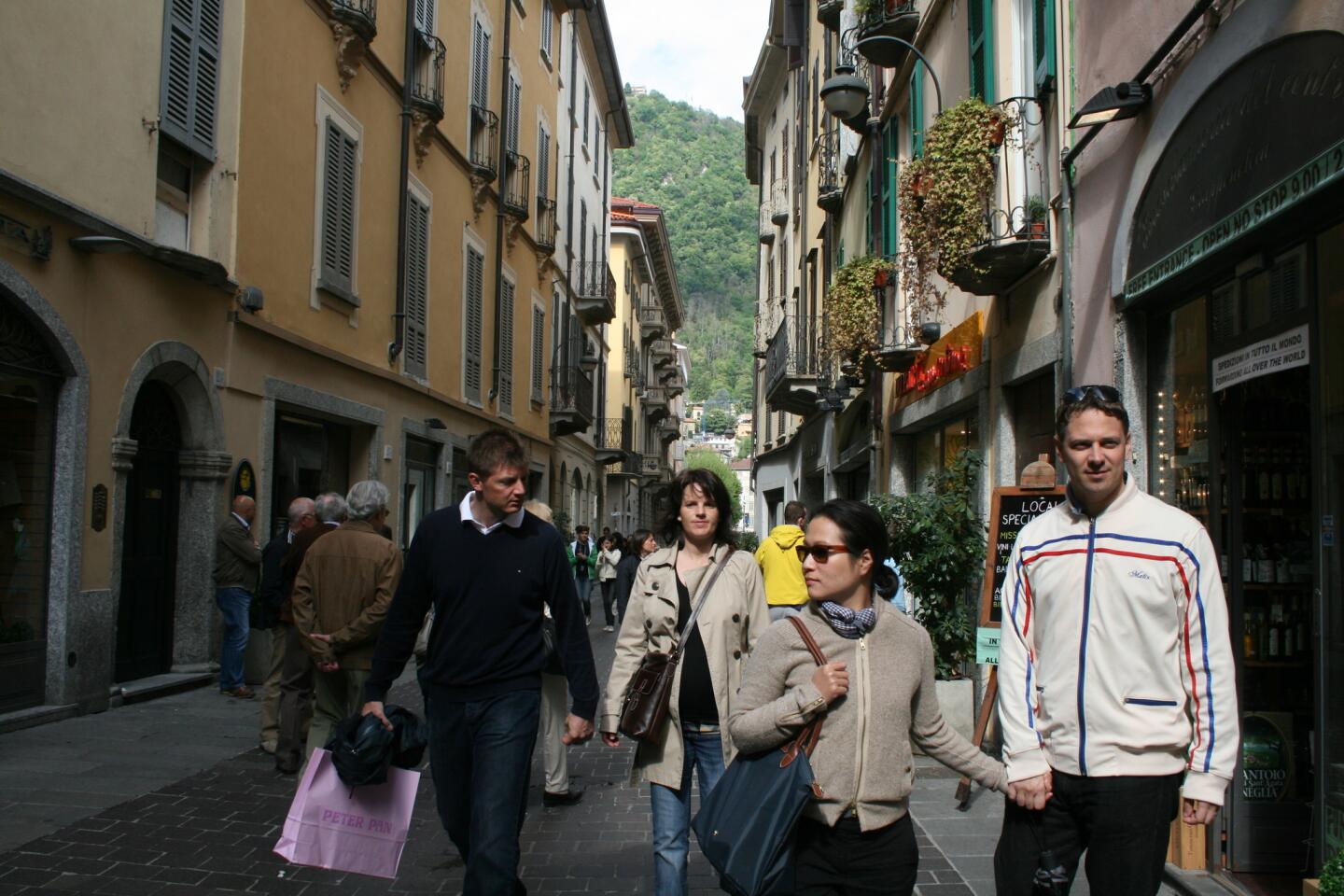 Visitors walk the streets of Como, located at the western terminus of Lake Como, the lake's largest town. Attractions include a funicular, cathedral, villas and museums.