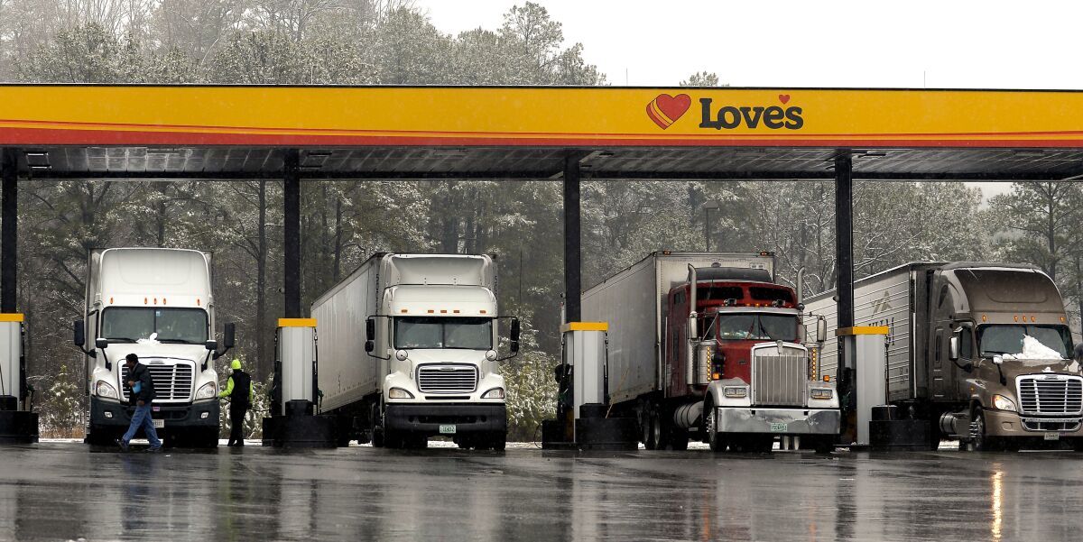 Truck drivers stop at a gas station in Emerson, Ga., north of metro Atlanta, to fill up their tractor trailer rigs. 