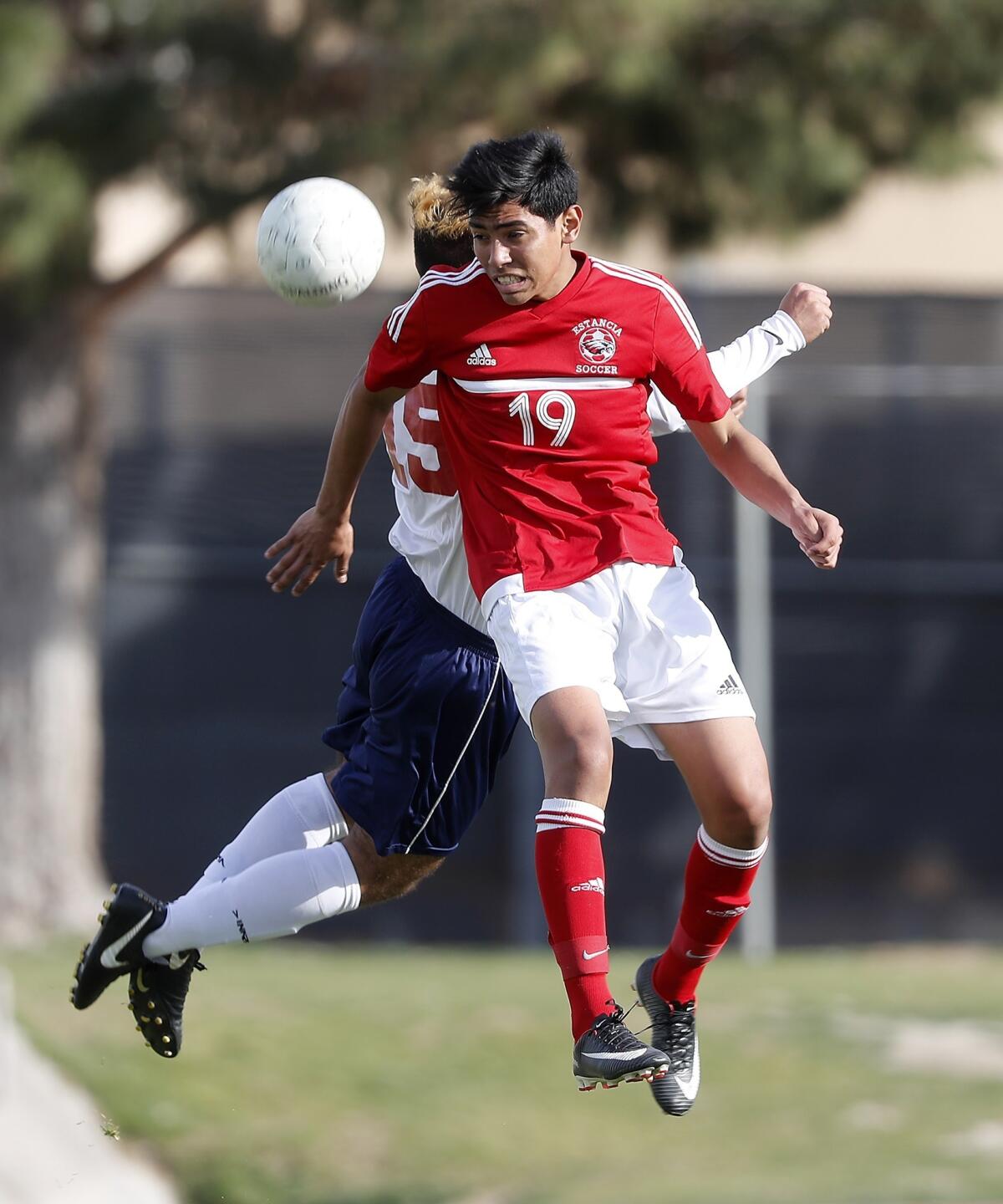 Estancia's Miguel Pena heads the ball in the first half at La Quinta in the second round of the CIF Southern Section Division 3 playoffs on Feb. 21, 2018.