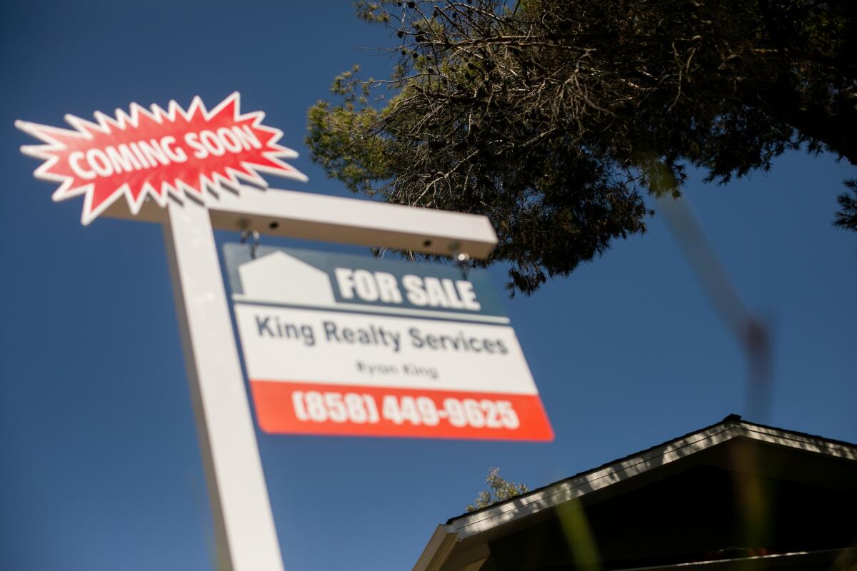 A 'For Sale' sign on the roof of a home