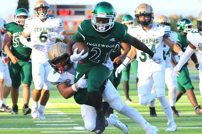 Running back Zion Garrett of Inglewood tries to break away against St. Bonaventure during his team's 47-7 win.