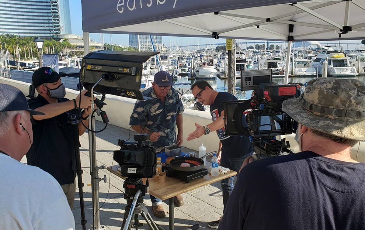 Tommy Gomes (center) films a scene of "The Fishmonger" in San Diego with TV cook Sam "The Cooking Guy" Zien.
