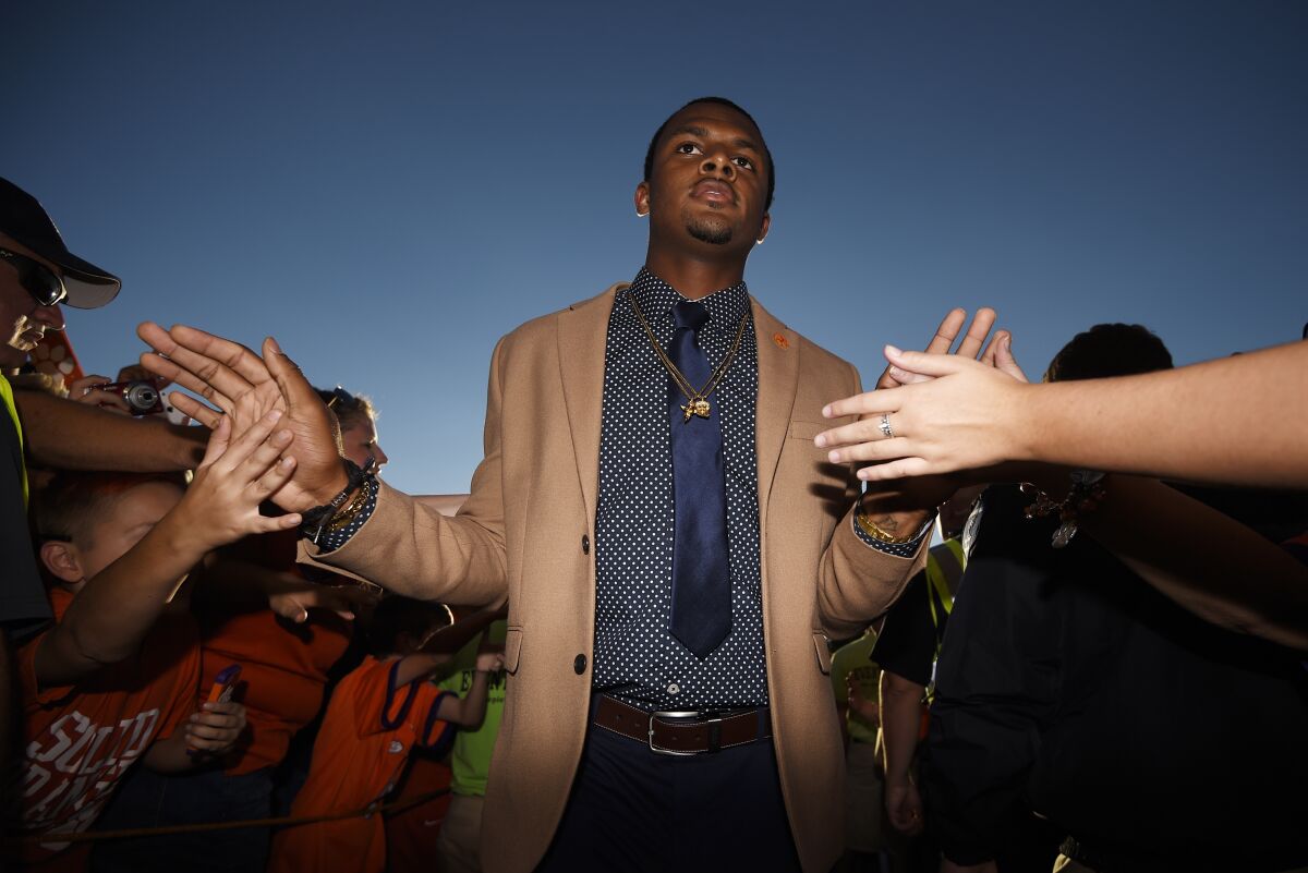 FILE - Clemson quarterback Deshaun Watson is greeted by fans before the team's NCAA college football game against Louisville on Saturday, Oct. 1, 2016, in Clemson, S.C. The NFL suspended Watson for six games on Monday, Aug. 1, 2022 for violating its personal conduct policy following accusations of sexual misconduct made against him by two dozen women in Texas, two people familiar with the decision said. (AP Photo/Rainier Ehrhardt, FIle)