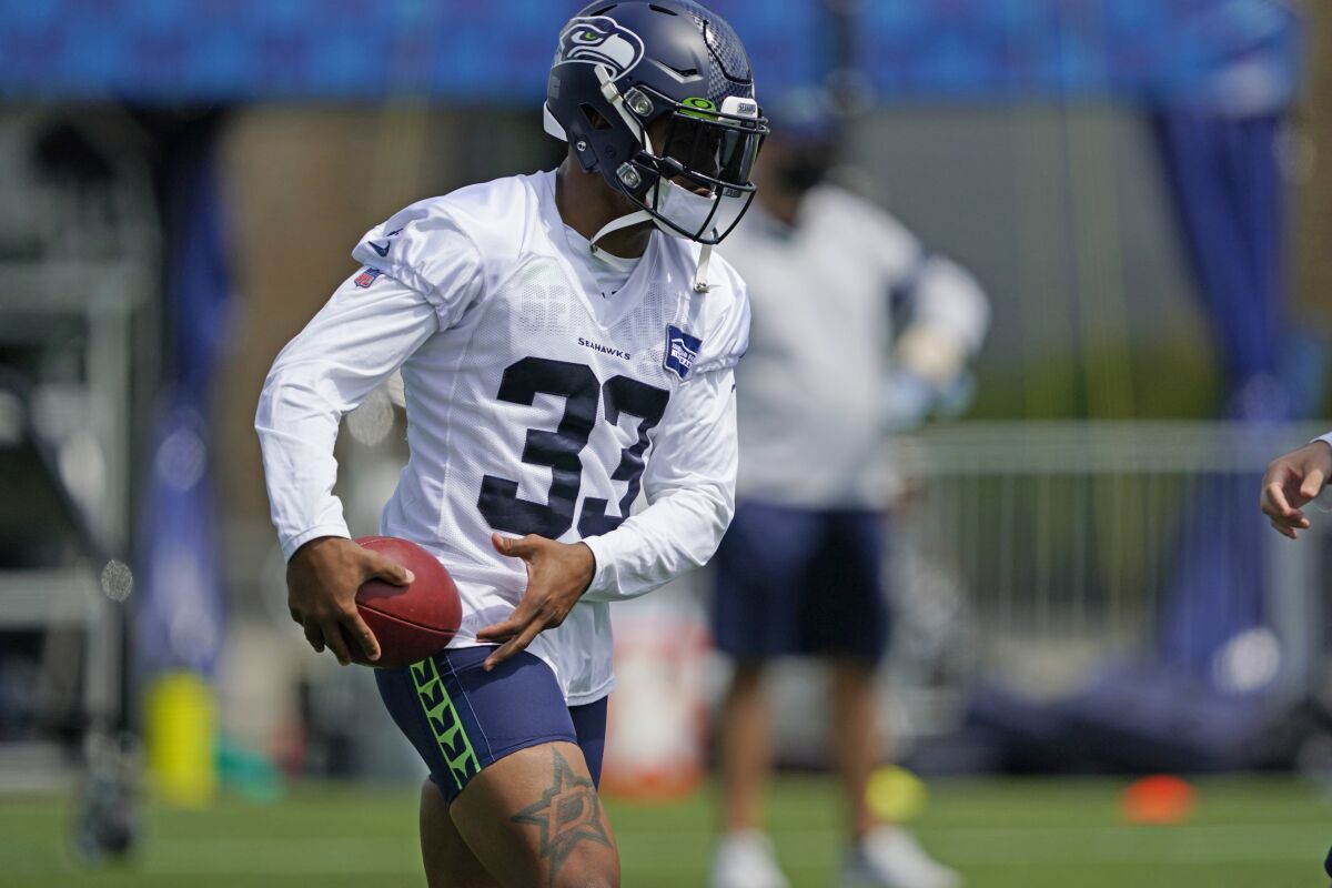 Seattle Seahawks safety Jamal Adams holds the football during a practice drill at NFL football training camp, Wednesday, Aug. 12, 2020, in Renton, Wash. (AP Photo/Ted S. Warren, Pool)