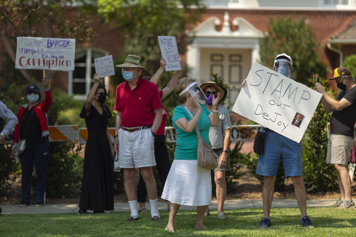 Protesters rally outside the home of USPS Board of Governors John M. Barger