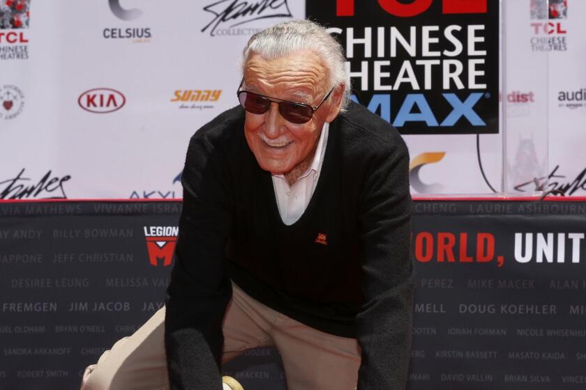 LOS ANGELES, CALIF. -- TUESDAY, JULY 18, 2017: Stan Lee, the iconic creator and legend of Marvel Comics, puts his handprints and footprints in cement at the TCL Chinese Theatre IMAX, former Grauman's Chinese Theatre, along Hollywood Blvd. in Los Angeles, Calif., on July 18, 2017. This was the first ever ceremony to be organized and hosted by a fan-owned entertainment company, Legion M. (Gary Coronado / Los Angeles Times)