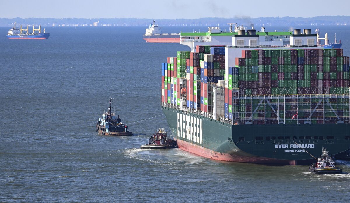 Evergreen Marine's Ever Forward container ship is taken to an anchorage south of the Chesapeake Bay Bridge after it was freed from mud outside the shipping channel off Pasadena, Md., where is had spent the past month aground. The cargo ship was traveling from Baltimore to Norfolk, Va., on March 13, when it ran aground just north of the Chesapeake Bay Bridge. (Jerry Jackson/The Baltimore Sun via AP)