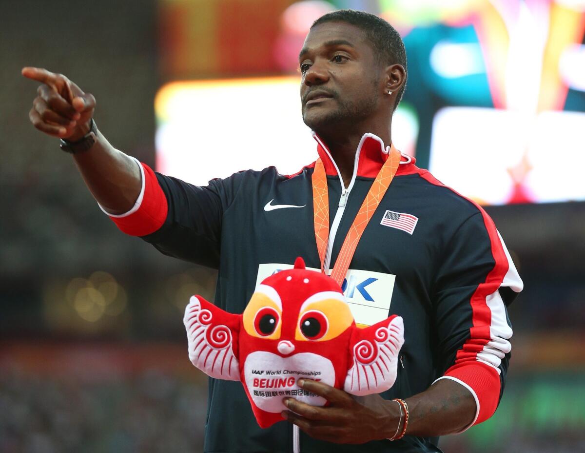 U.S. sprinter Justin Gatlin gestures on the podium after winning the silver medal in the men's 100 meters during the world championships in Beijing.