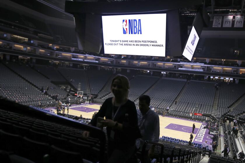 Fans leave the Golden 1 Center after the NBA basketball game between the New Orleans Pelicans and Sacramento Kings was postponed at the last minute in Sacramento, Calif., Wednesday, March 11, 2020. The league said the decision was made out of an "abundance of caution," because official Courtney Kirkland, who was scheduled to work the game, had worked the Utah Jazz game earlier in the week. A player for the Jazz tested positive for the coronavirus. (AP Photo/Rich Pedroncelli)