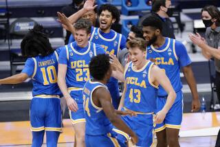 UCLA basketball players celebrate their win over BYU after a first-round game in the NCAA college basketball.