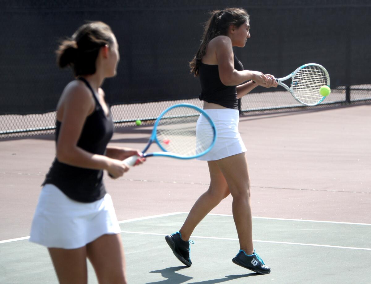 Glendale High School girls' tennis doubles player Nicole Avakian returns the serve in match at Burroughs High School in Burbank, on Tuesday, Sept. 10, 2019.