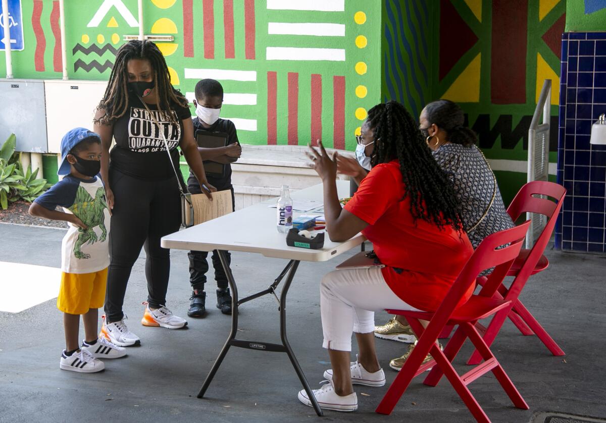 A kindergartner meets his teacher at Baldwin Hills Elementary School on Aug. 18, 2020. 