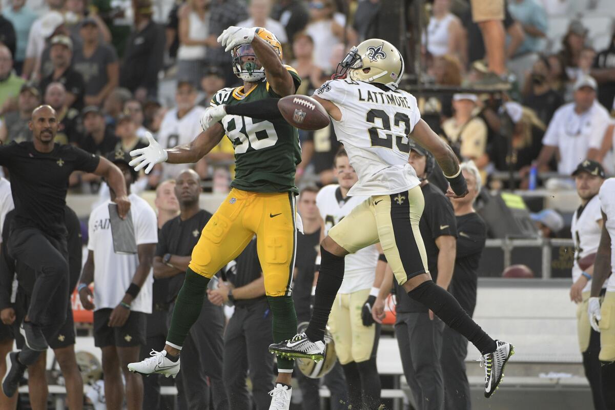 New Orleans Saints cornerback Marshon Lattimore (23) breaks up a pass intended for Green Bay Packers wide receiver Malik Taylor, left, during the second half of an NFL football game, Sunday, Sept. 12, 2021, in Jacksonville, Fla. (AP Photo/Phelan M. Ebenhack)