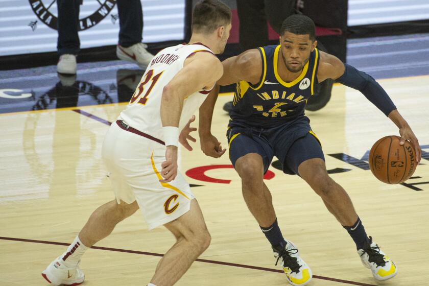 Indiana Pacers' Cassius Stanley (2) drives past Cleveland Cavaliers' Matt Mooney (31) during the second half of an NBA preseason basketball game Monday, Dec. 14, 2020 in Cleveland. (AP Photo/Phil Long)