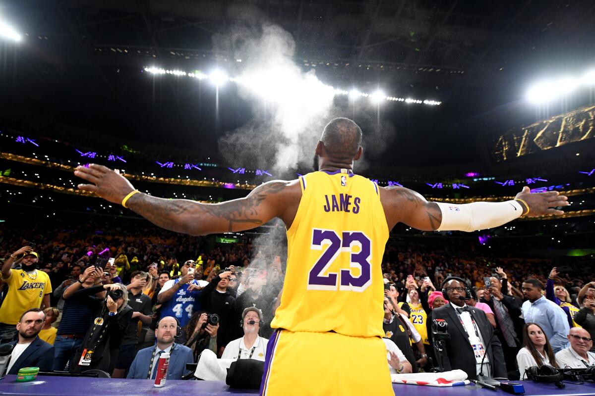 LeBron James tosses chalk powder into the air before Thursday's win over the Phoenix Suns at Crypto.com Arena.