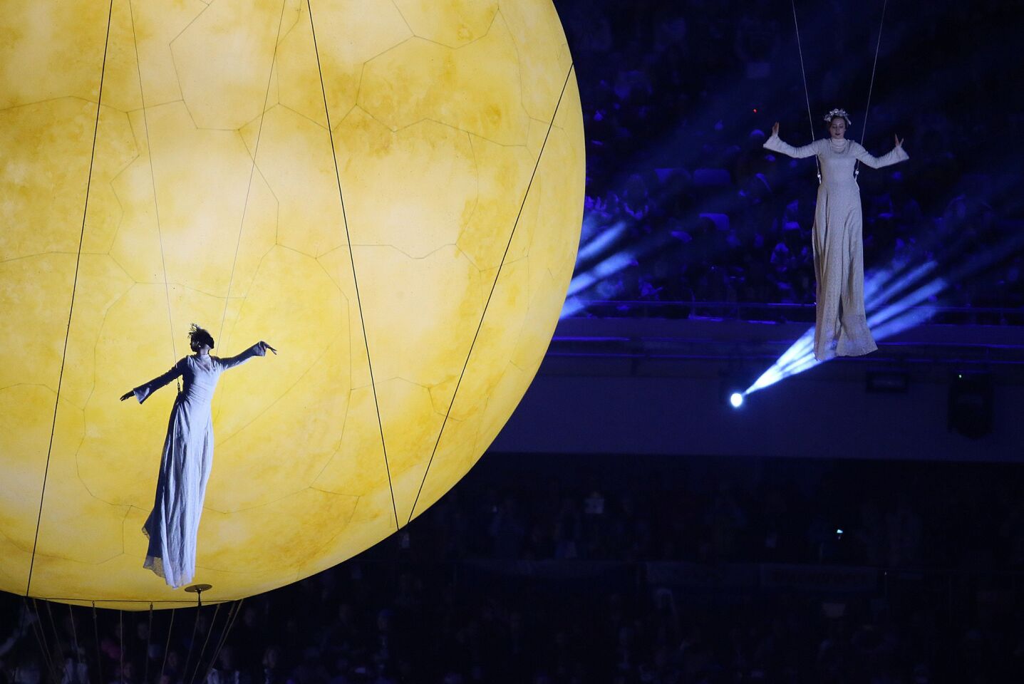 Actors perform with a large orb during the 2014 Winter Olympics Closing Ceremony.