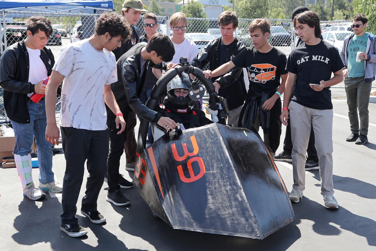 Huntington Beach High School electric race car team prepare to compete in the Energy Invitational at UC Irvine on Saturday.