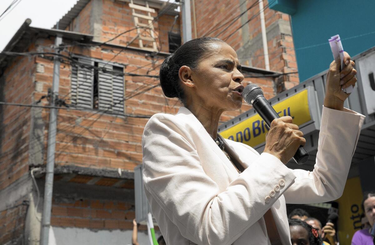 Presidential candidate Marina Silva campaigns in a slum in Sao Paulo, Brazil on Oct. 1. She has attacked incumbent Dilma Rousseff’s handling of the economy.