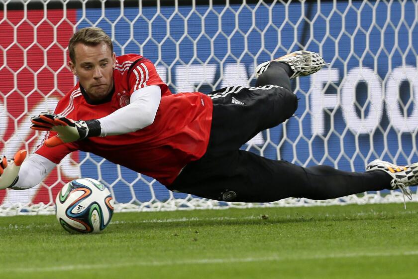 Germany goalkeeper Manuel Neuer makes a save during a team training session Monday. Bruce Arena believes the Germans will prevail over Brazil in the World Cup semifinals Tuesday.