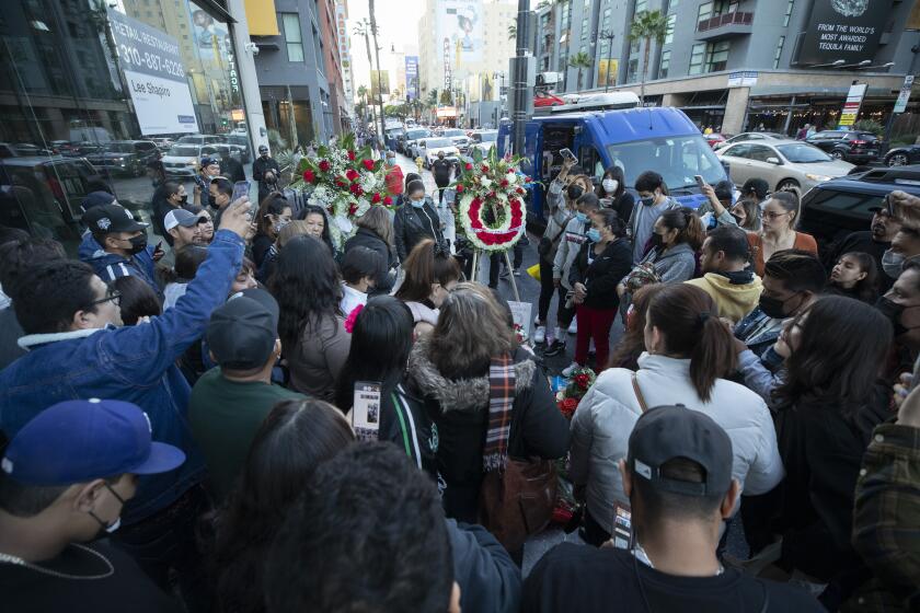 HOLLYWOOD, CA - DECEMBER 12: Fans gather around Vicente Fernandez's star on Hollywood Boulevard singing his songs during a makeshift memorial on Sunday, Dec. 12, 2021. (Myung J. Chun / Los Angeles Times)