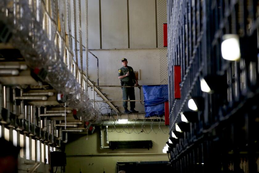 SAN QUENTIN, CALIFORNIA, DECEMBER 29, 2015: A guard stands watch over the condemned prisoners housed in East Block during a media tour of Death Row at San Quentin prison December 29, 2015. The media were given a rare view of death row at San Quentin in the North Block, East Block, and the Adjustment Center (Mark Boster/Los Angeles Times)