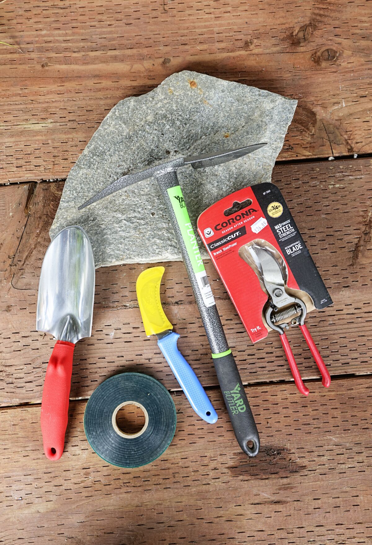 A garden trowel, tie tape, harvesting blade, maddock and pruner.