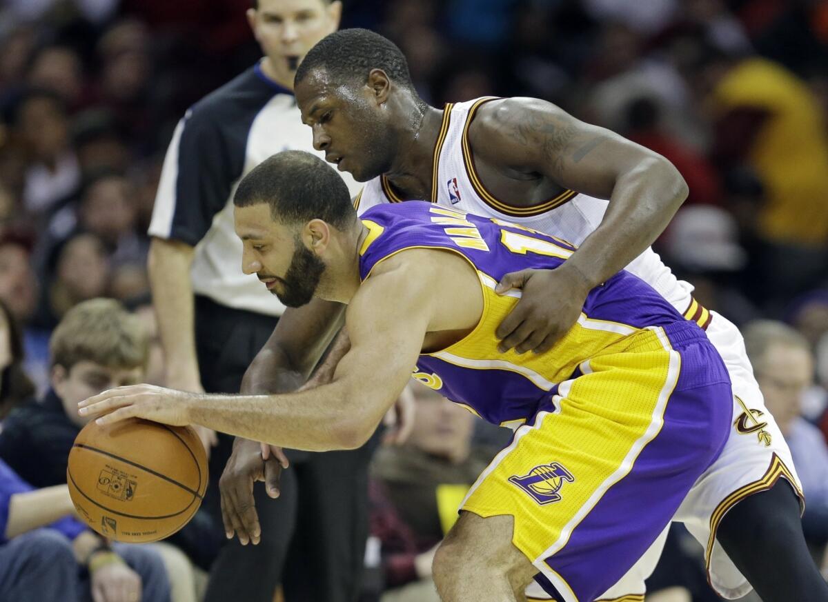 Kendall Marshall is defended by Cleveland's Dion Waiters during the fourth quarter of the Lakers' 119-108 win Wednesday over the Cavaliers.