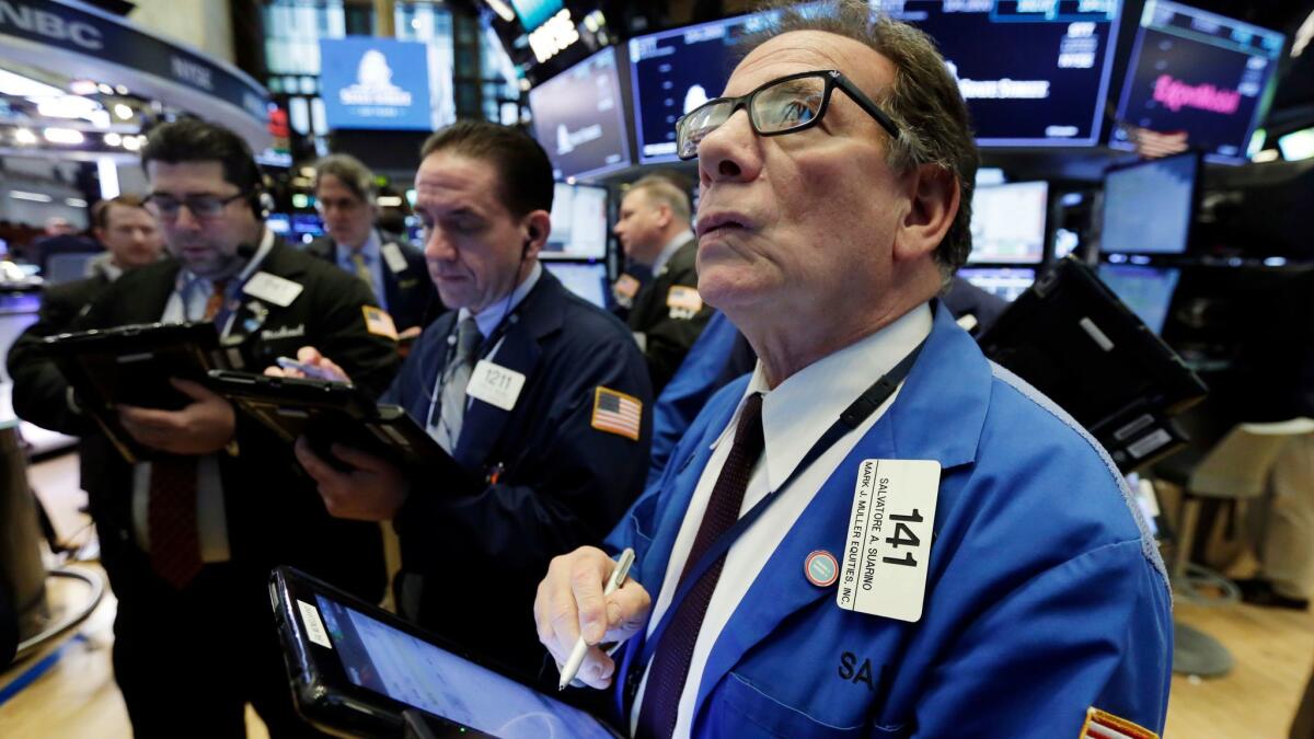 Traders work on the floor of the New York Stock Exchange.