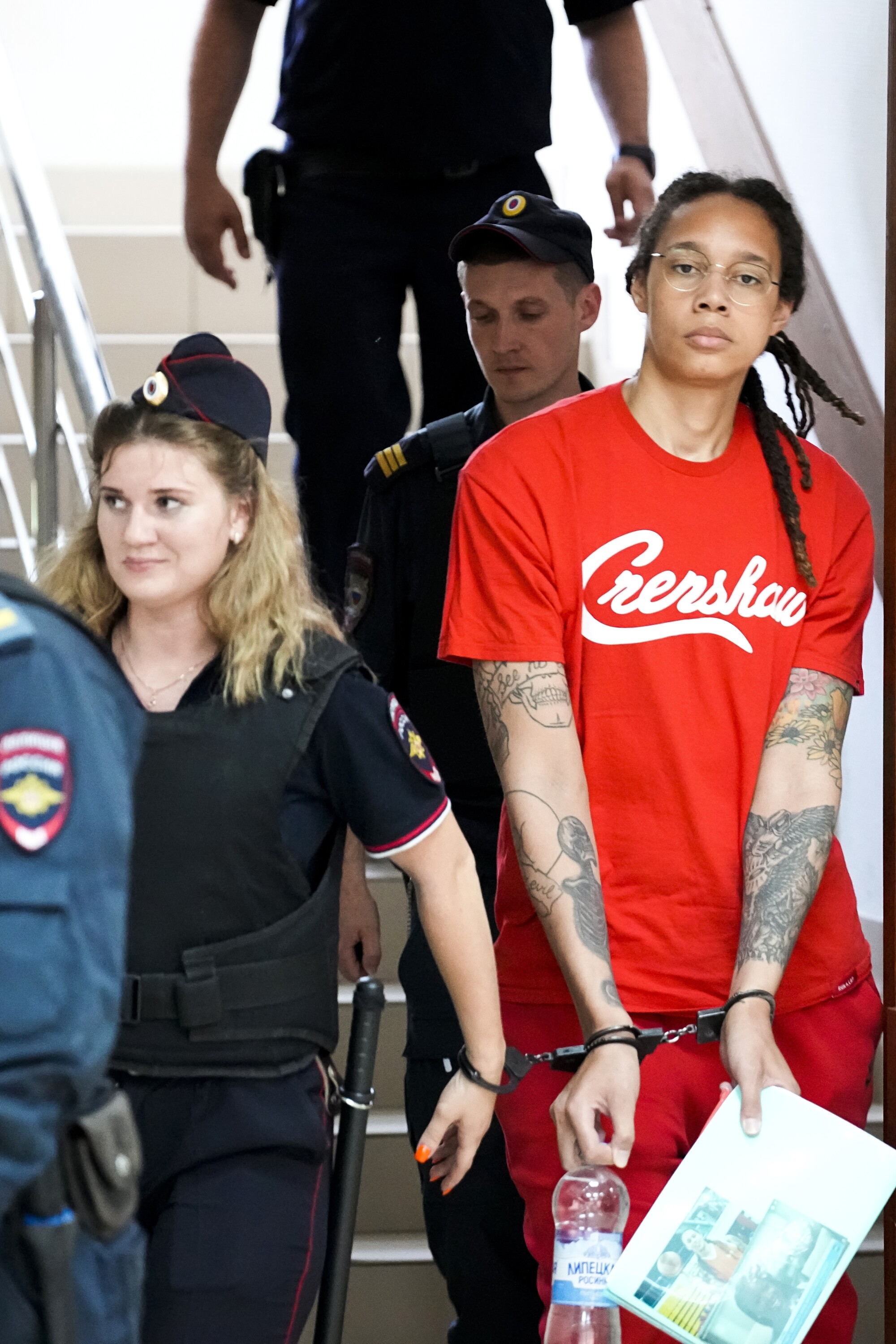 WNBA star and two-time Olympian Brittney Griner is escorted into the courtroom for a hearing.