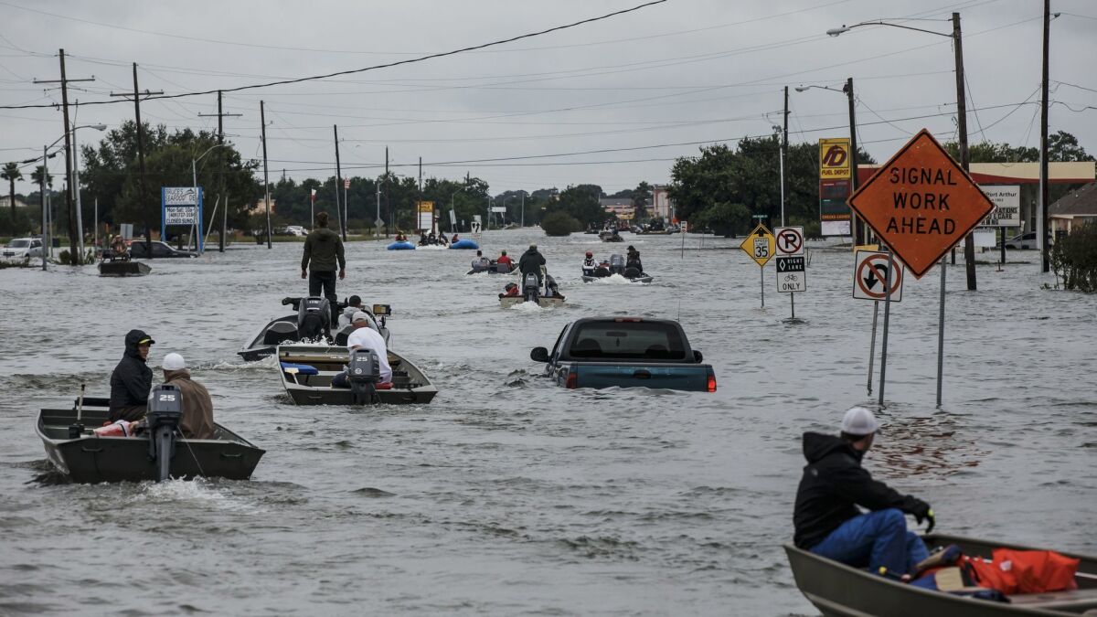 Boaters head out in search of stranded residents in Port Arthur, Texas, on Wednesday.