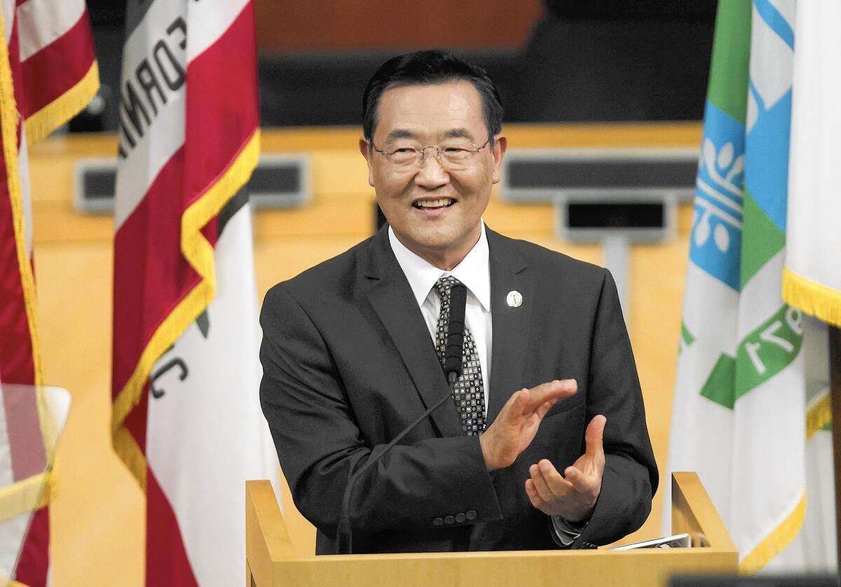 Irvine Mayor Steven Choi applauds city staff as he delivers his State of the City address Tuesday night at the Irvine Civic Center.