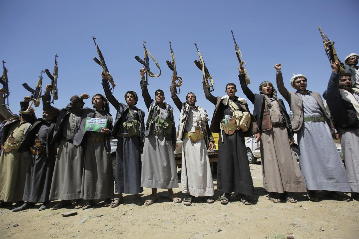 Shiite Houthi tribesmen hold their weapons as they chant slogans during a tribal gathering in Sana, Yemen, in 2019.  