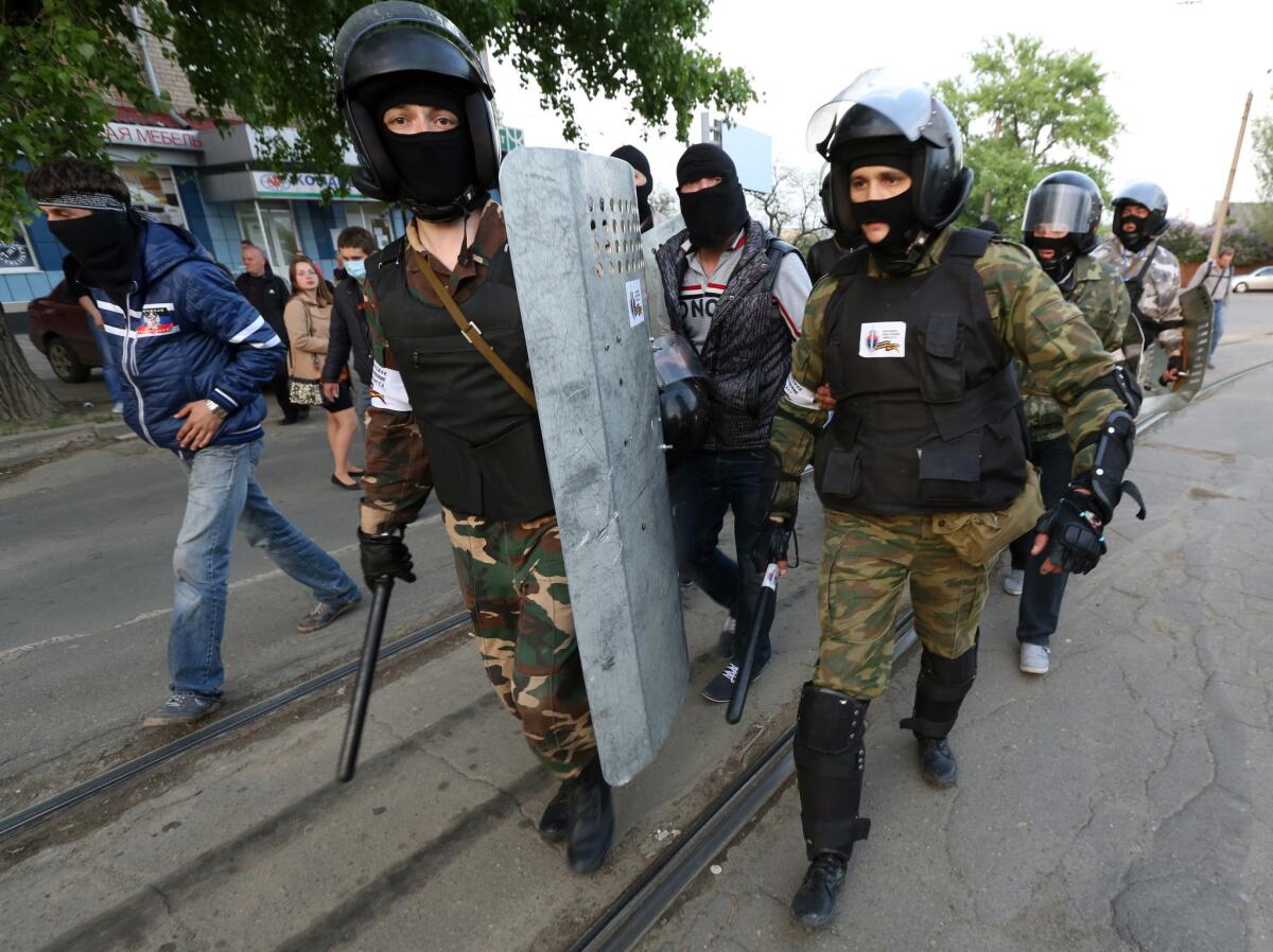 A separatist "self-defense" unit marches through the center of the eastern Ukraine city of Donetsk on Sunday.