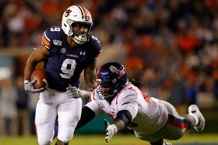 AUBURN, ALABAMA - NOVEMBER 02: Kam Martin #9 of the Auburn Tigers rushes away from Josiah Coatney #40 of the Mississippi Rebels in the first half at Jordan-Hare Stadium on November 02, 2019 in Auburn, Alabama. (Photo by Kevin C. Cox/Getty Images) ** OUTS - ELSENT, FPG, CM - OUTS * NM, PH, VA if sourced by CT, LA or MoD **