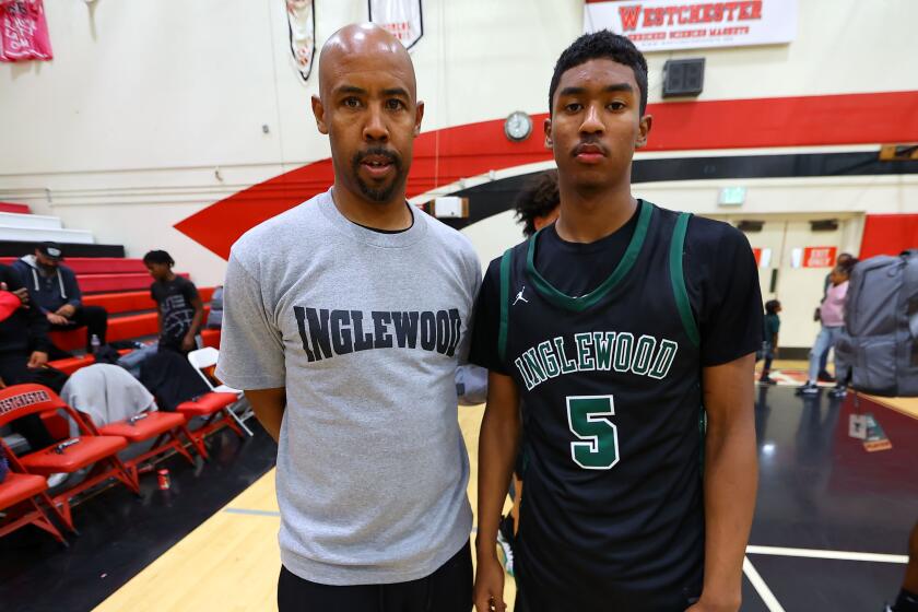 Jason Crowe Jr. (right) and his father. Crowe scored 55 points for Inglewood in an opening game of the Classic at Damien.