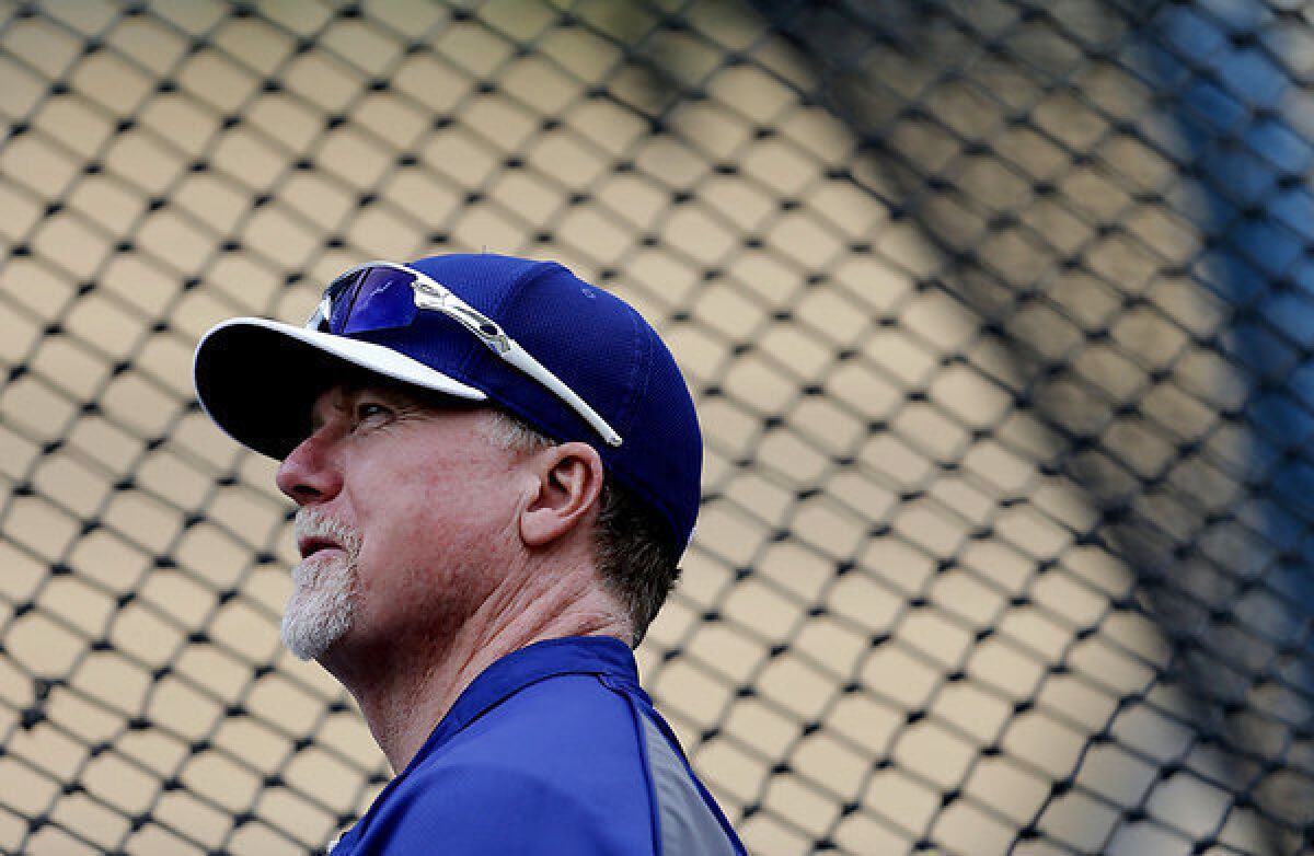 Dodgers hitting coach Mark McGwire watches batting practice before a game against the Diamondbacks.