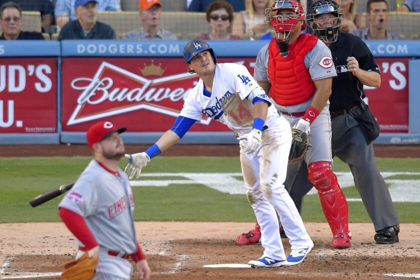 Dodgers' Enrique Hernandez drops his bat after hitting a three-run home run in the second inning Saturday night against Cincinnati.