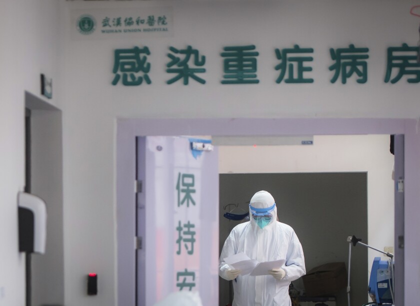 A doctor wears protective clothing to care for patients at a hospital in Wuhan, China. On Tuesday, Chinese authorities agreed to allow the World Health Organization to send international experts to China to assist with research and containment of the coronavirus outbreak.