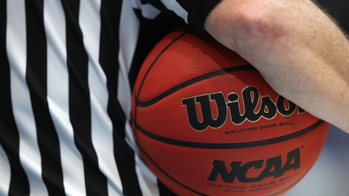 A referee holds a game ball during the 2019 NCAA Men's Basketball Tournament in Hartford, Conn. on March 21.