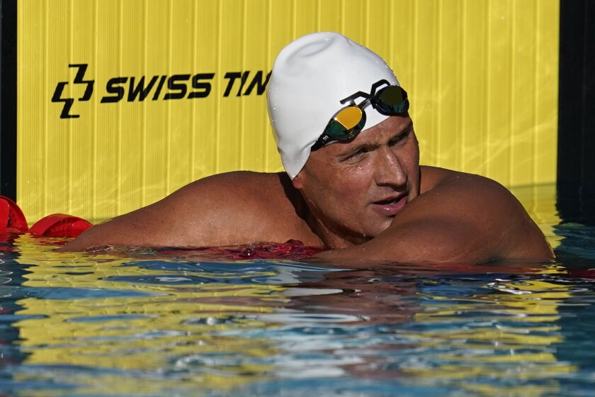 FILE - In this April 8, 2021, file photo, Ryan Lochte pauses after competing in the men's 200-meter freestyle preliminary race at the TYR Pro Swim Series swim meet in Mission Viejo, Calif. Lochte, the swimmer who embarrassed himself and the U.S. five years ago in Rio de Janeiro, is seeking to make a record-tying Olympic team. (AP Photo/Ashley Landis, File)