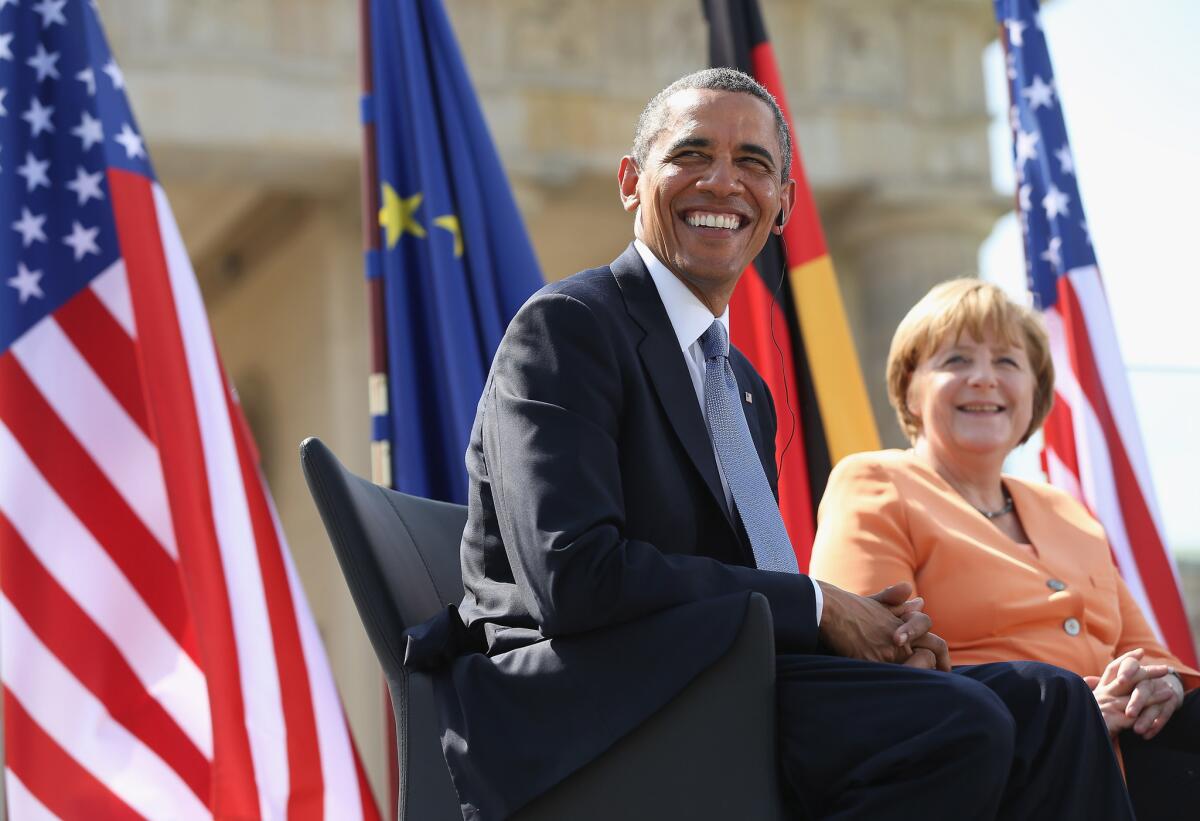 President Obama and German Chancellor Angela Merkel arrive to speak at the Brandenburg Gate in Berlin.